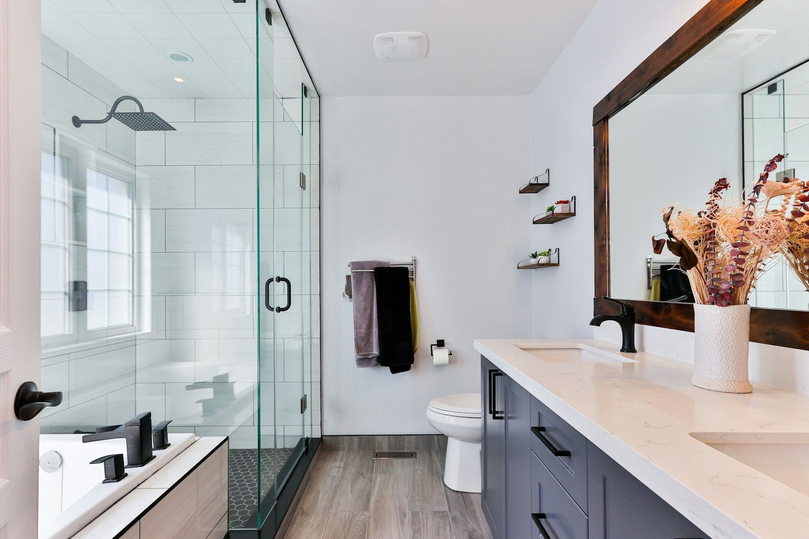Bathroom with a glass shower, a vanity and a large mirror