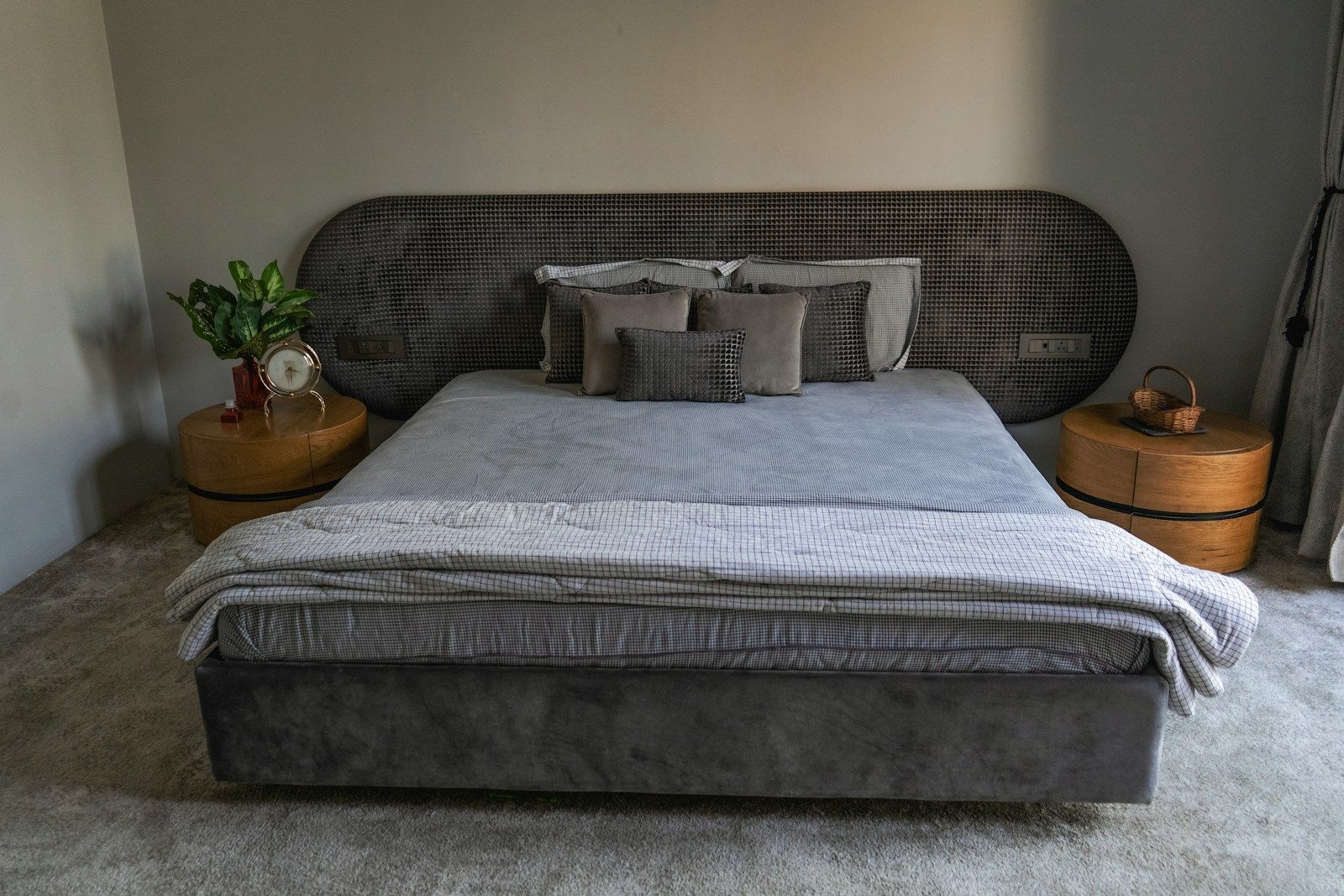 Bedroom with a grey upholstered bed and two side tables